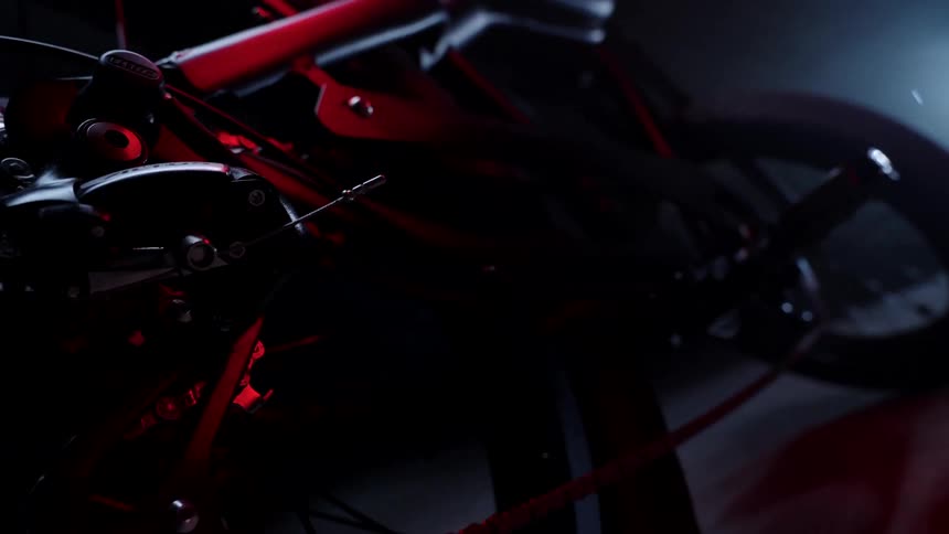 A bike is parked in the dark garage