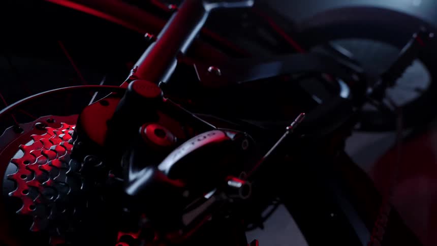 Orbiting around the gears of a bicycle on a dark room