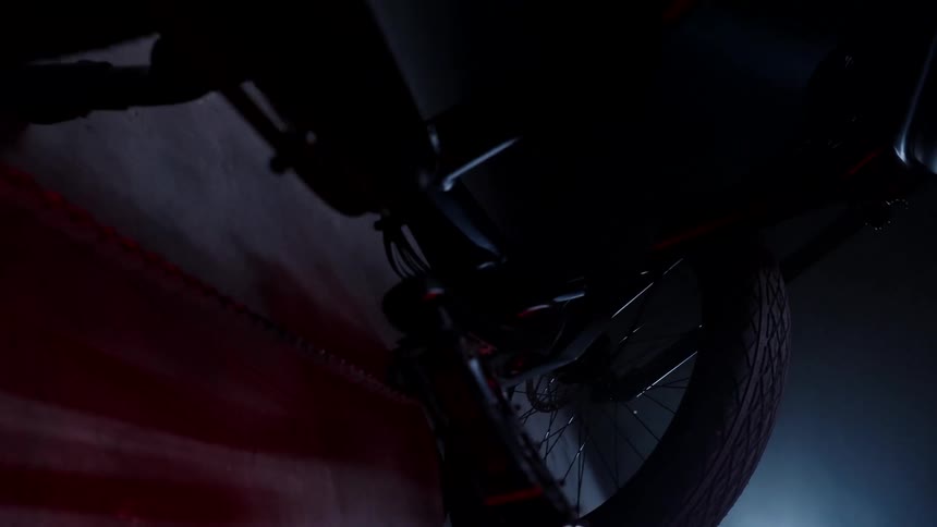 The bike is parked in the dark