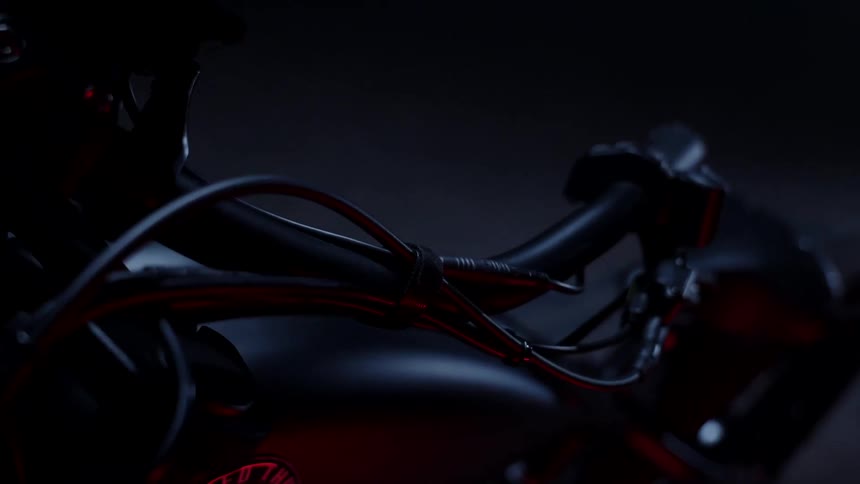 A black motorcycle is parked in the garage