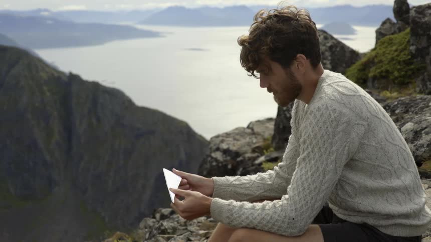 An imaginative adventurer creates a temporary toy while enjoying a peaceful mountain escape alone.