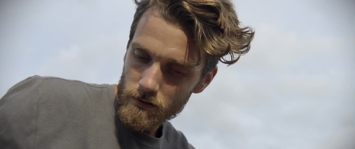A thoughtful explorer pauses during a difficult hike to clear his mind and rest.