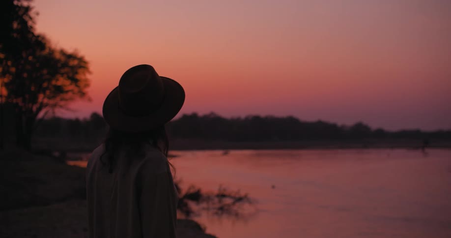 A woman walks by the lake