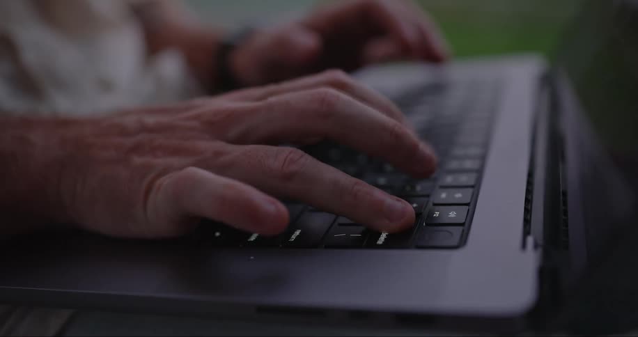 A person is typing on his laptop