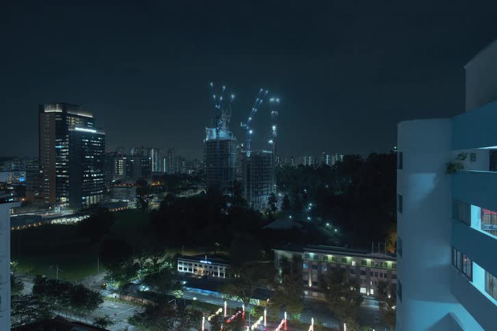 A construction site rises in a dark scene at night