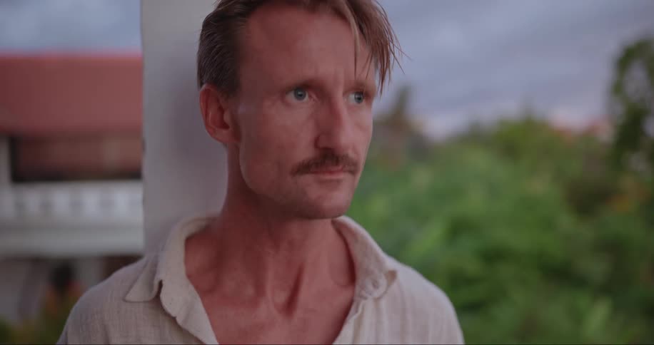 Close up of the face of a man working on the hotel balcony