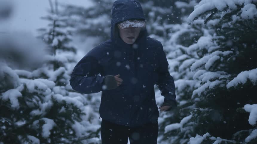 Woman jogging in the forest at winter