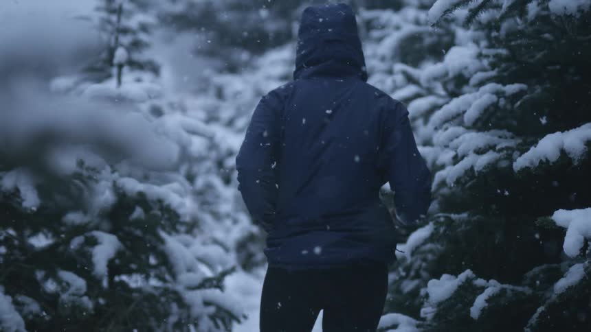Woman jogging in the forest at winter