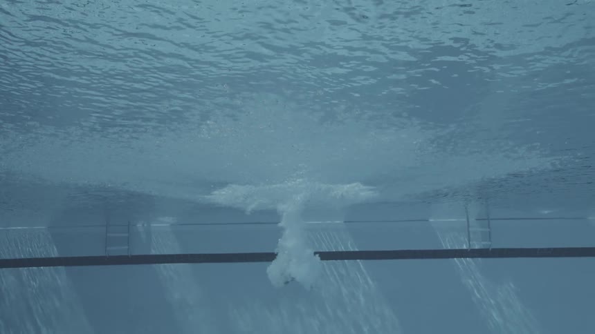 A person jumps into the pool