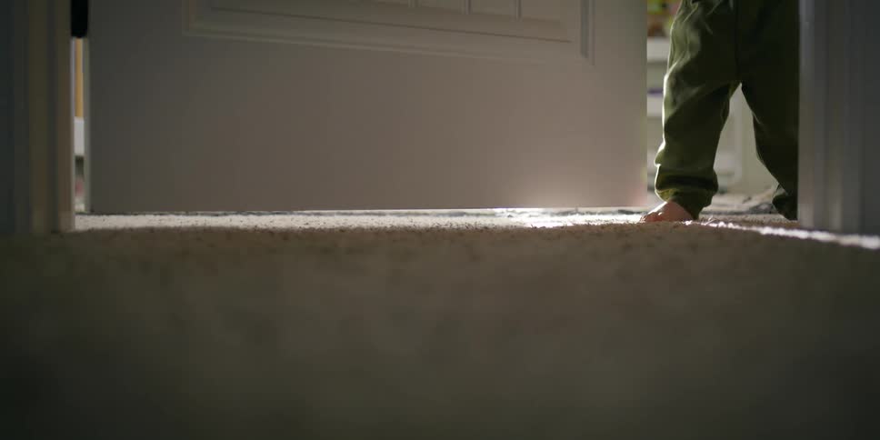 Toddler opens the door of his bedroom