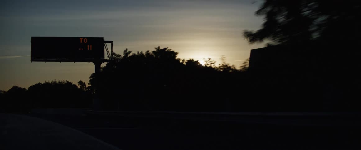 A busy suburban highway at dawn