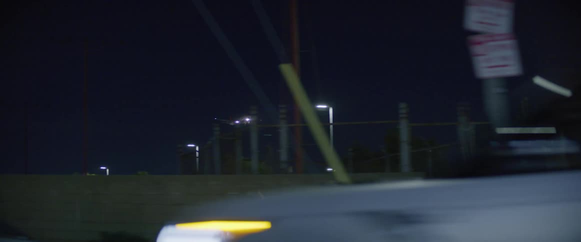 An airplane flying over the urban city at night