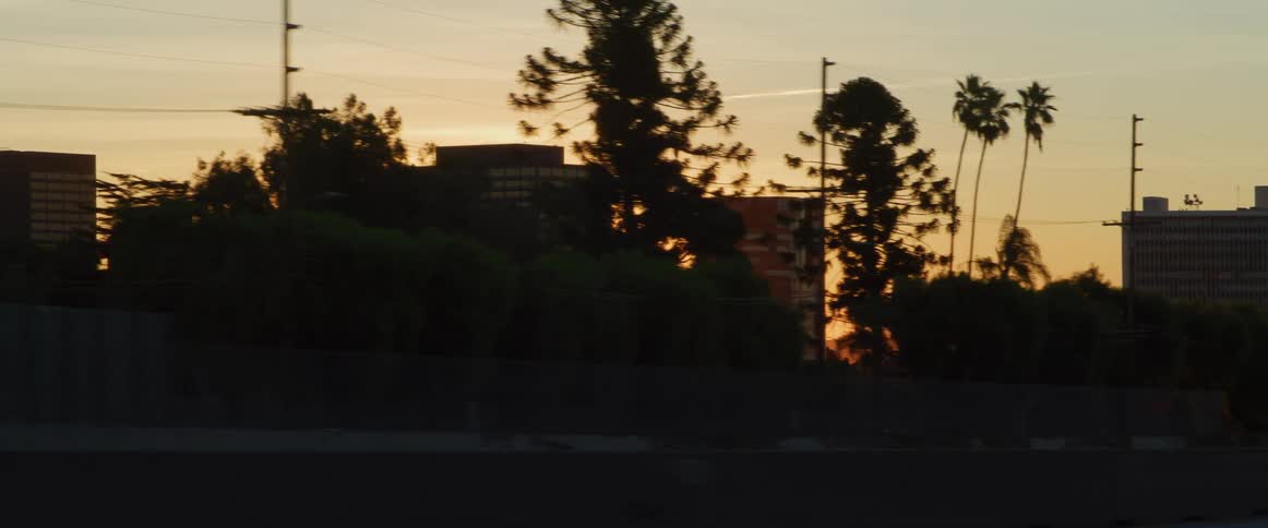 Traffic runs on the freeway by the city