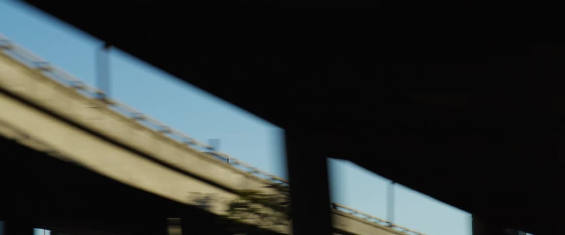 Airplane flying over the city seen from a moving vehicle