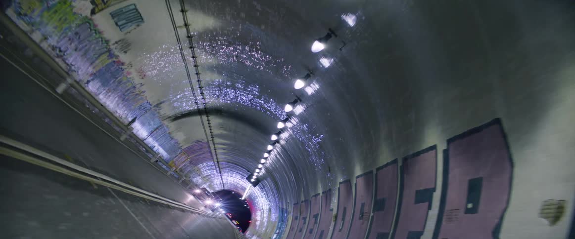 A road inside a tunnel decorated with graffiti art