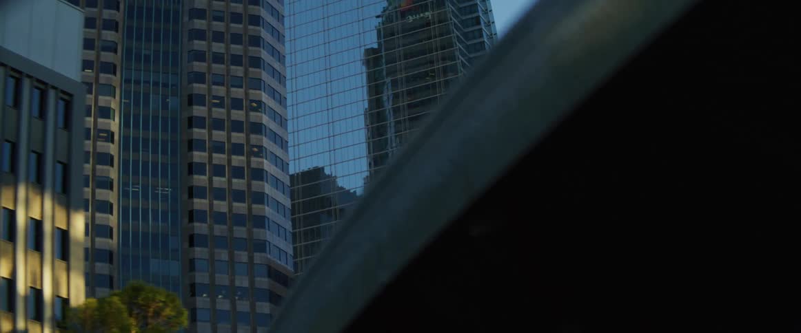 The tall buildings have reflective windows
