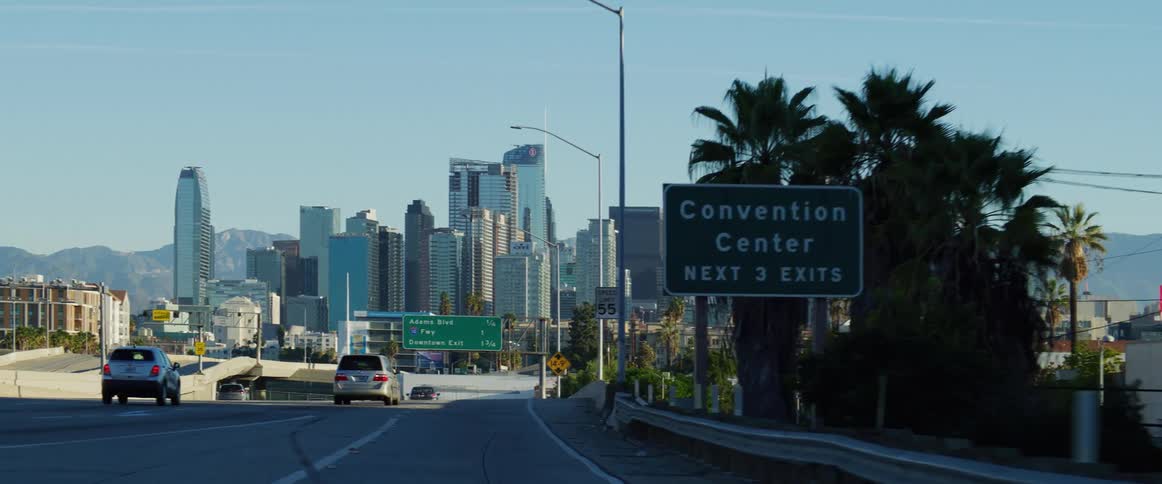 Traffic runs on the freeway by the city