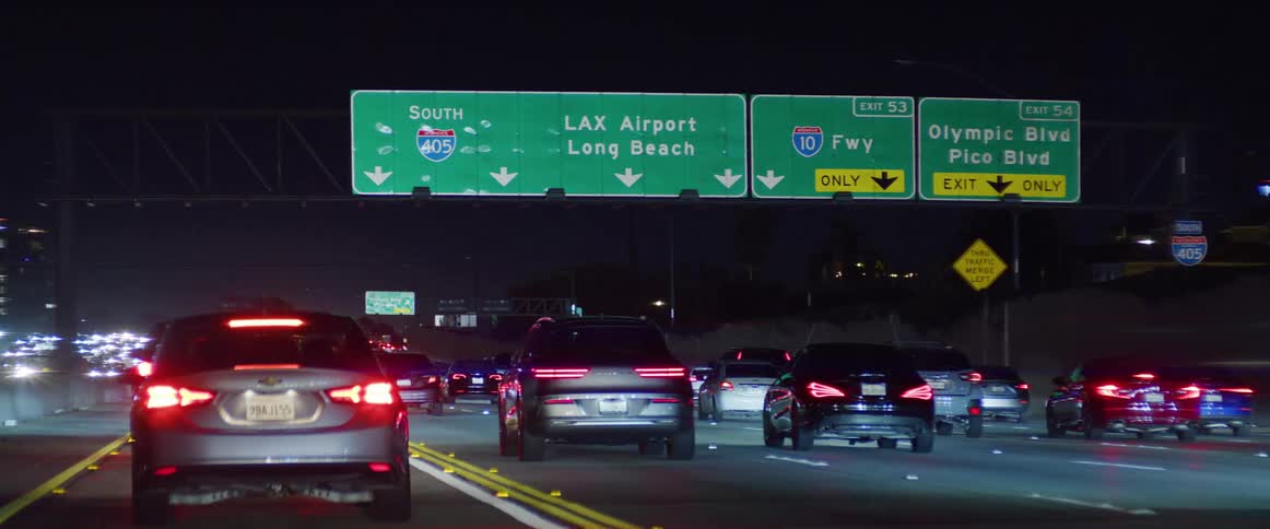 Seven lanes of taillights illuminating a california freeway near olympic blvd exits at night