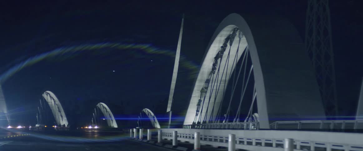 Arches of a road bridge in the city at night