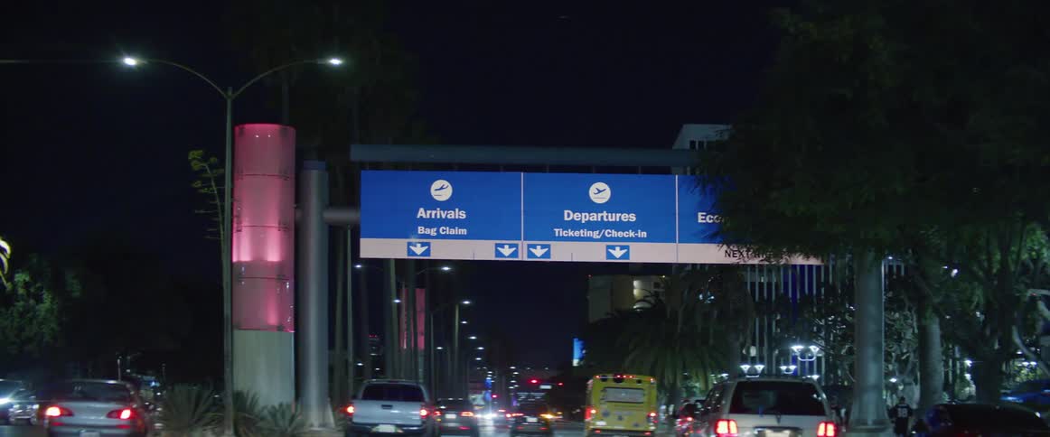 Vehicles driving on the airport roads at night