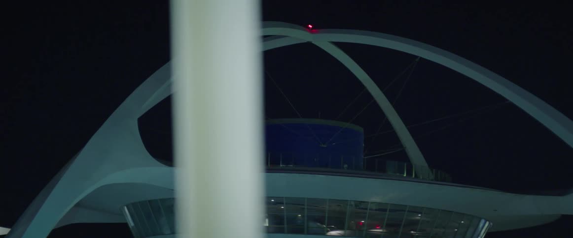 A radio control tower is under the night sky