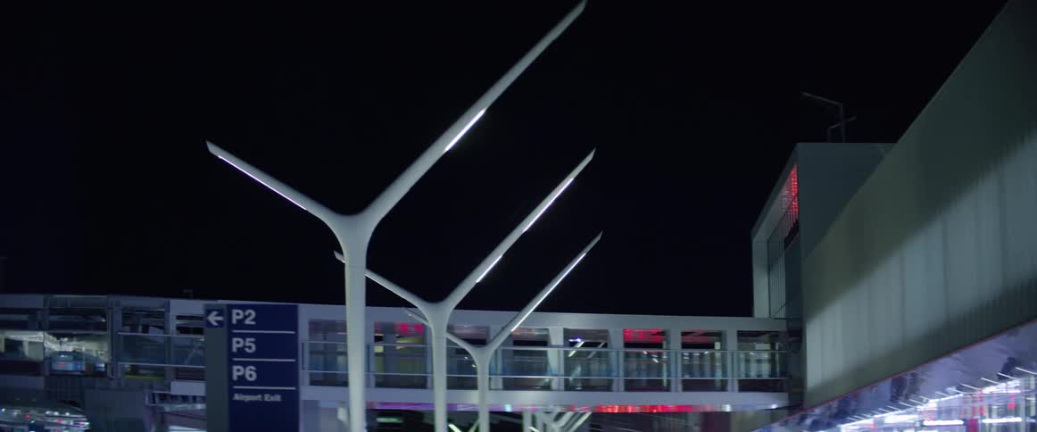 Pedestrian overpass at the airport seen from a moving vehicle