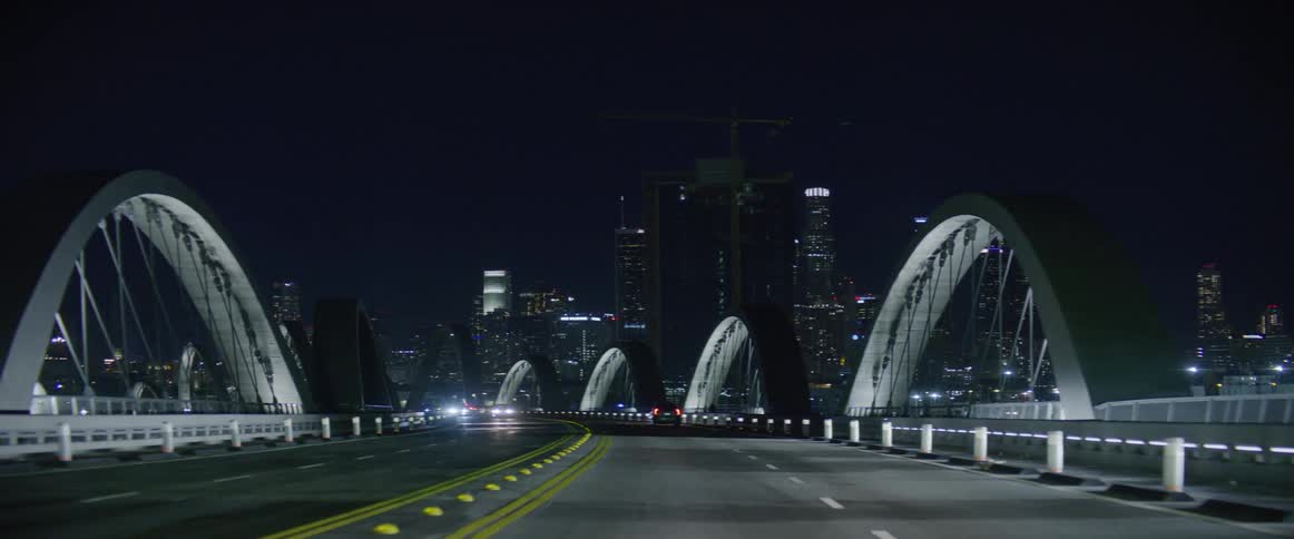 A highway with calm traffic in the metropolitan city at night