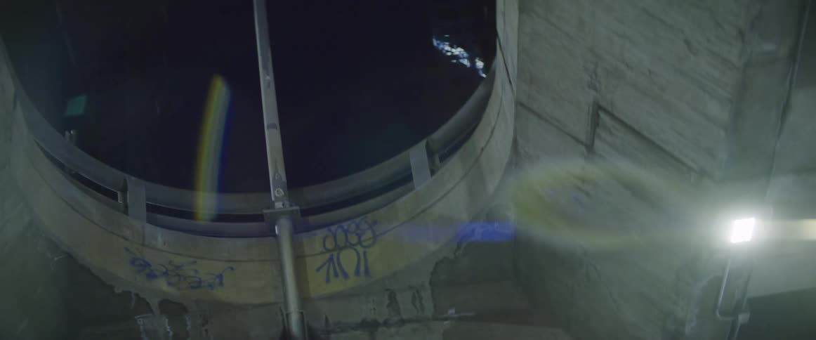 Underside of an overpass in the city at night