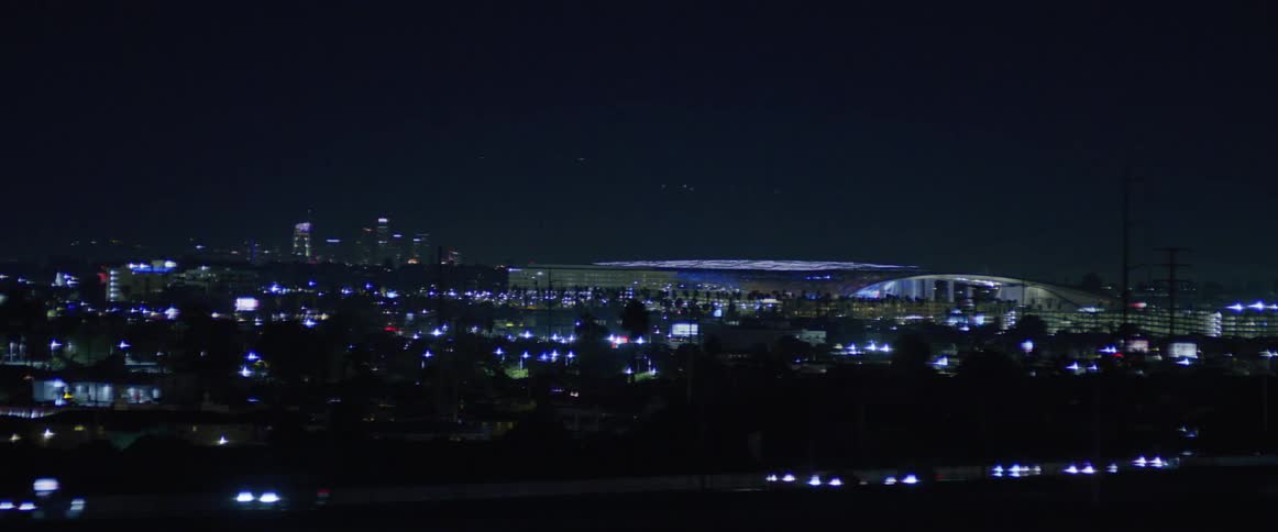 Airport terminal at night seen from a moving vehicle