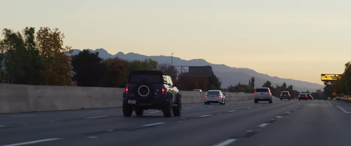 Cars driving on the highway at sunset