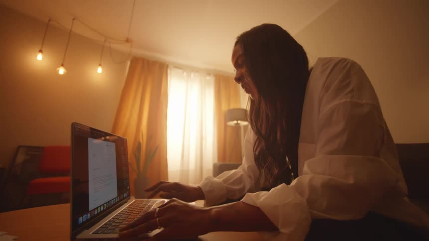Woman sitting in the living room working on a laptop