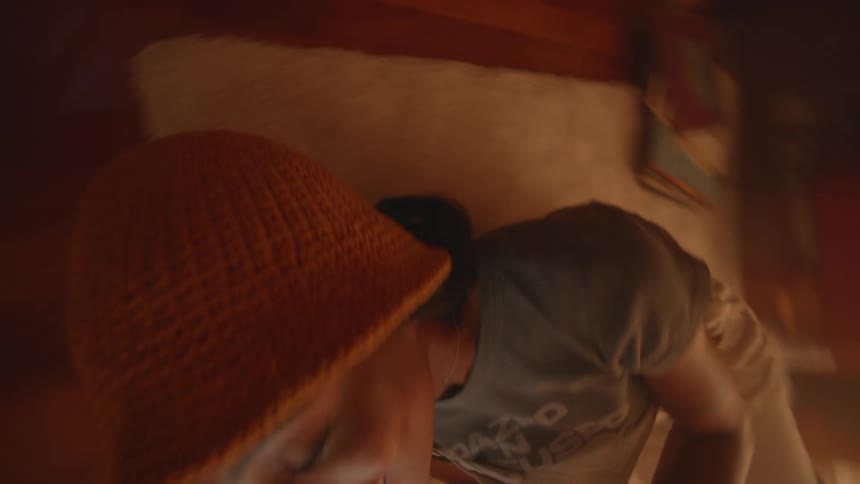 Teenager lying on the floor rolls over with a smile while viewing a tablet