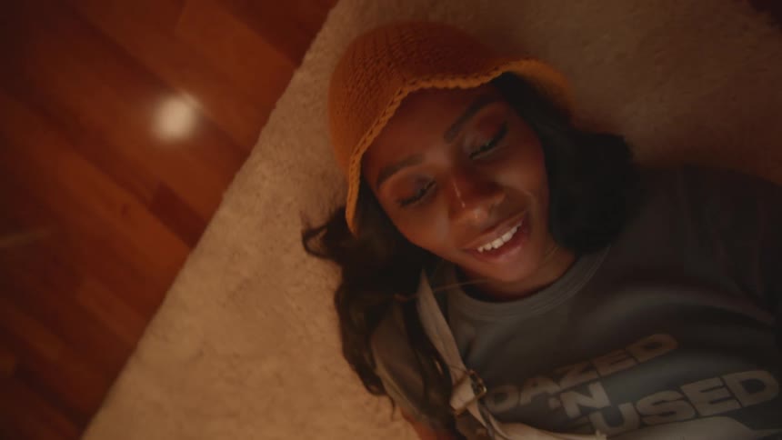 A woman lying on the living room floor using a tablet
