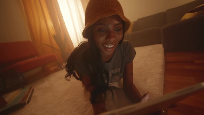 A woman looks at her tablet and rolls over