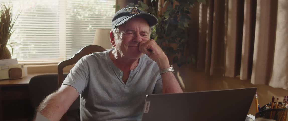 Elderly man working from home lost in tought