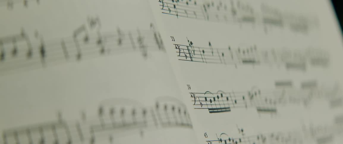 A printed book of sheet music with notes and scores