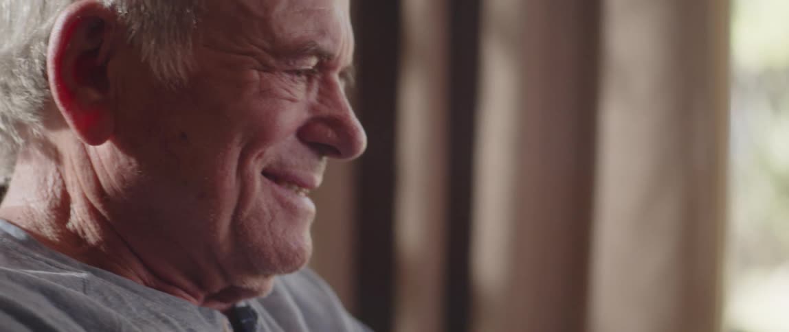 Closeup of a happy old mans baseball cap