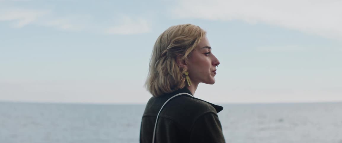 A woman is looking out over the ocean