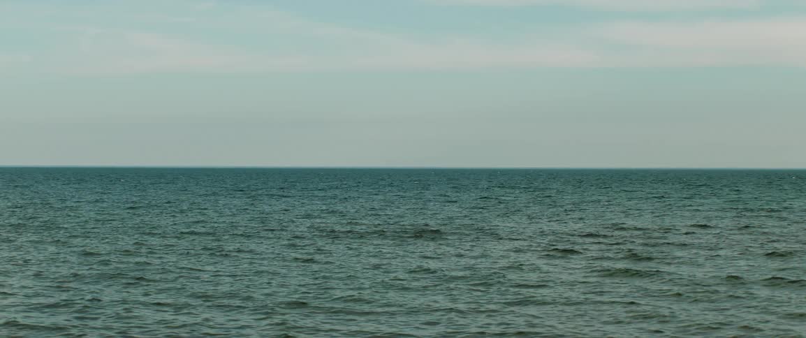 Sunlight reflects on the water as it ripples and waves