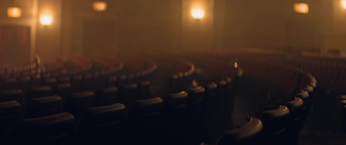 Rows of empty seats in a historic theater