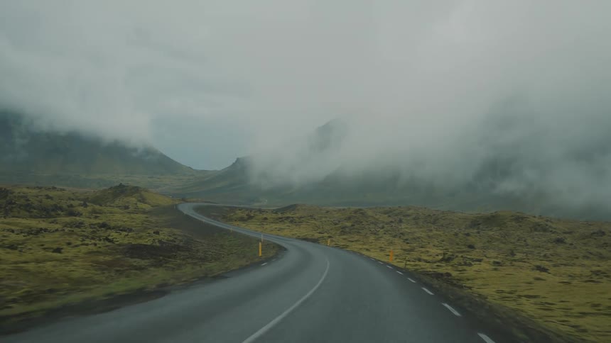 A deserted road in the natural landscape of hills and mountains