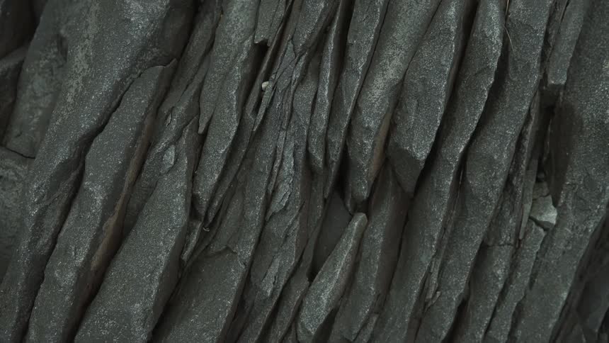 Gray shale rock formation of crevasses and sharp ridge peaks
