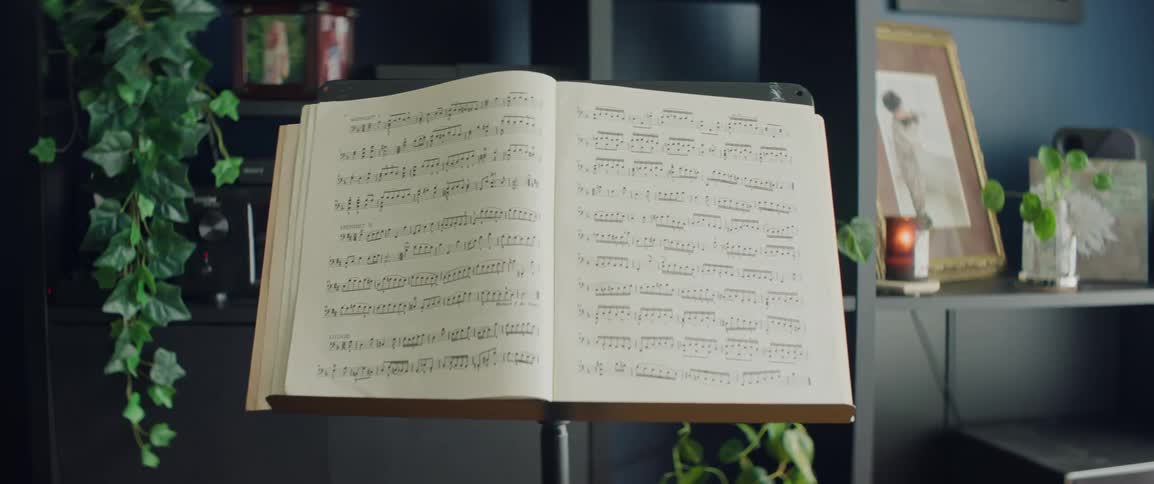 A book of classical sheet music is open with many notes