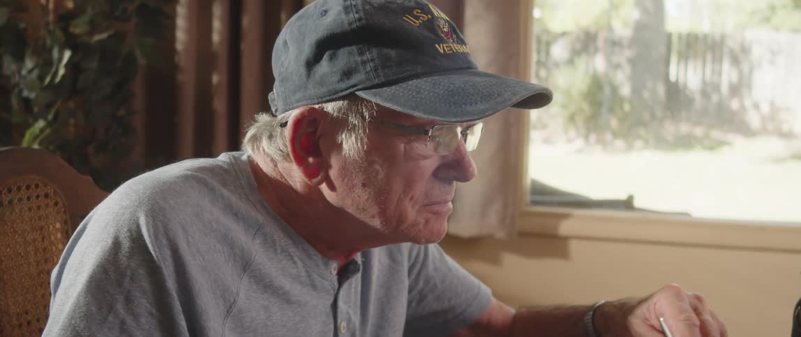 Closeup of an elderly person sitting and reading a newspaper