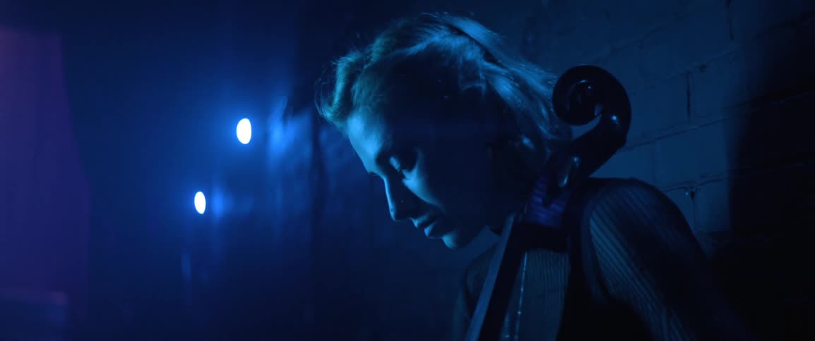 Musician practicing cello in the backstage