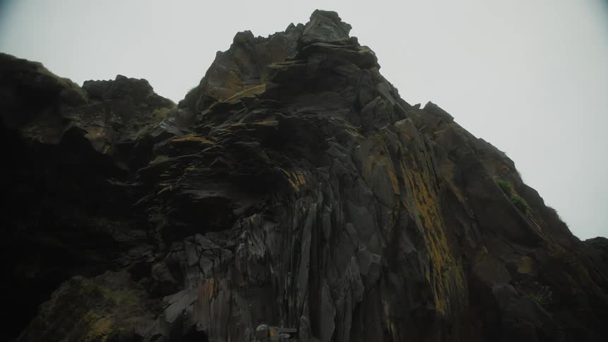 Dark rugged mountain peak under a gloomy sky