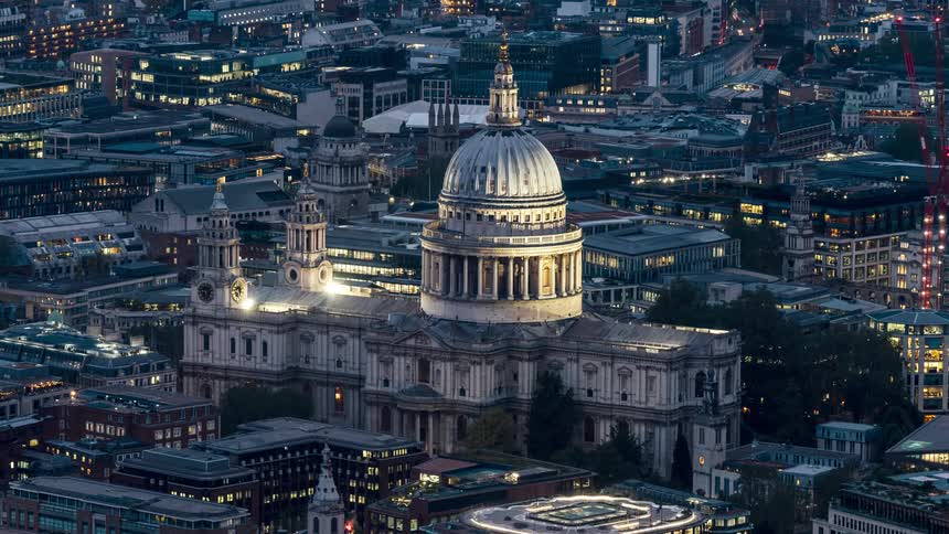 St pauls cathedral shines brightly against a cityscape at night