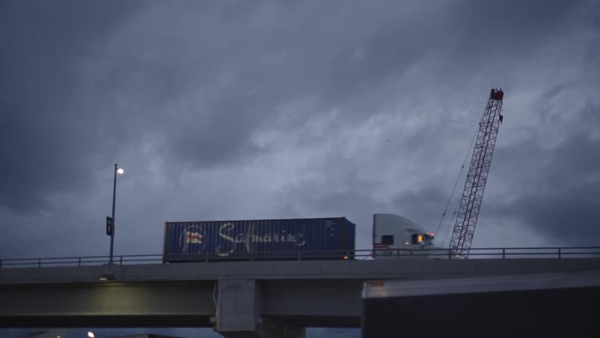 A truck drives over the overpass