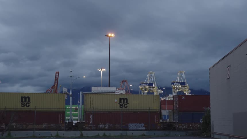 Train with containers passing by a logistics center port