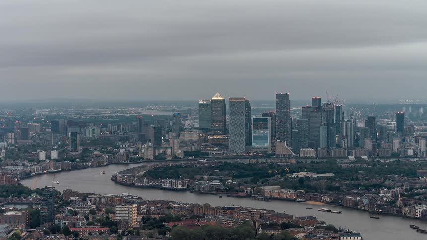 Aerial panorama of a metropolis in timelapse with waterfront skyscrapers on a cloudy day
